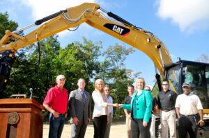 Kelli Fabick (left), marketing manager for Fabick CAT, hands off the keys to Missouri S&T Chancellor Cheryl B. Schrader. Also pictured from left: Jimmie Taylor, supervisor, Experimental Mine, University of Missouri System President Timothy Wolfe and Steve Berkebile, Eastern North America Region manager for Caterpillar Global Mining. Dr. Samuel Frimpong, the Robert H. Quenon Chair of Mining Engineering at Missouri S&T, is on the far right.