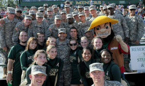 Soldiers from nearby Fort Leonard Wood, Mo., pose with Missouri S&T cheerleaders and mascot Joe Miner during S&T's annual Military Appreciation Day football game.