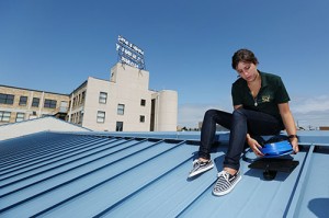 Tatiana Lopes, an undergraduate student from Brazil, conducted light and shadow studies on the roof of Phelps County Bank's downtown drive-through as part of the solar installation project.