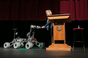 Chancellor Cheryl B. Schrader receives her script from Phoenix, the Mars rover designed by Missouri S&T students, at the beginning of her Fall 2014 State of the University Address.