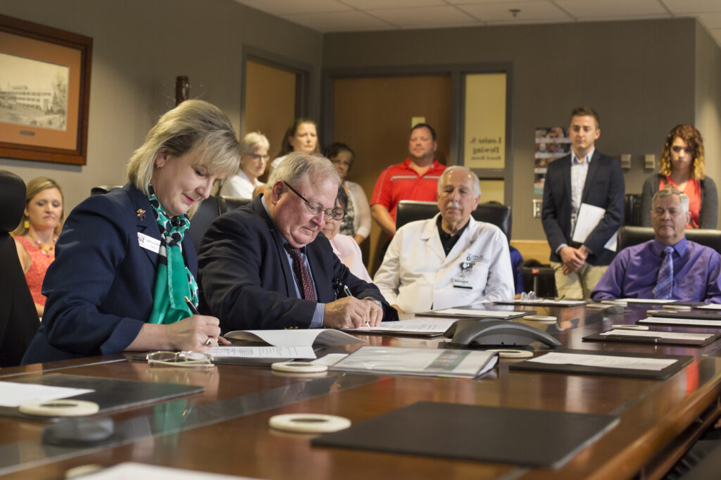 Missouri S&T Chancellor Cheryl B. Schrader and Phelps County Regional Medical Center CEO John Denbo sign a memorandum of understanding on July 2, 2015.