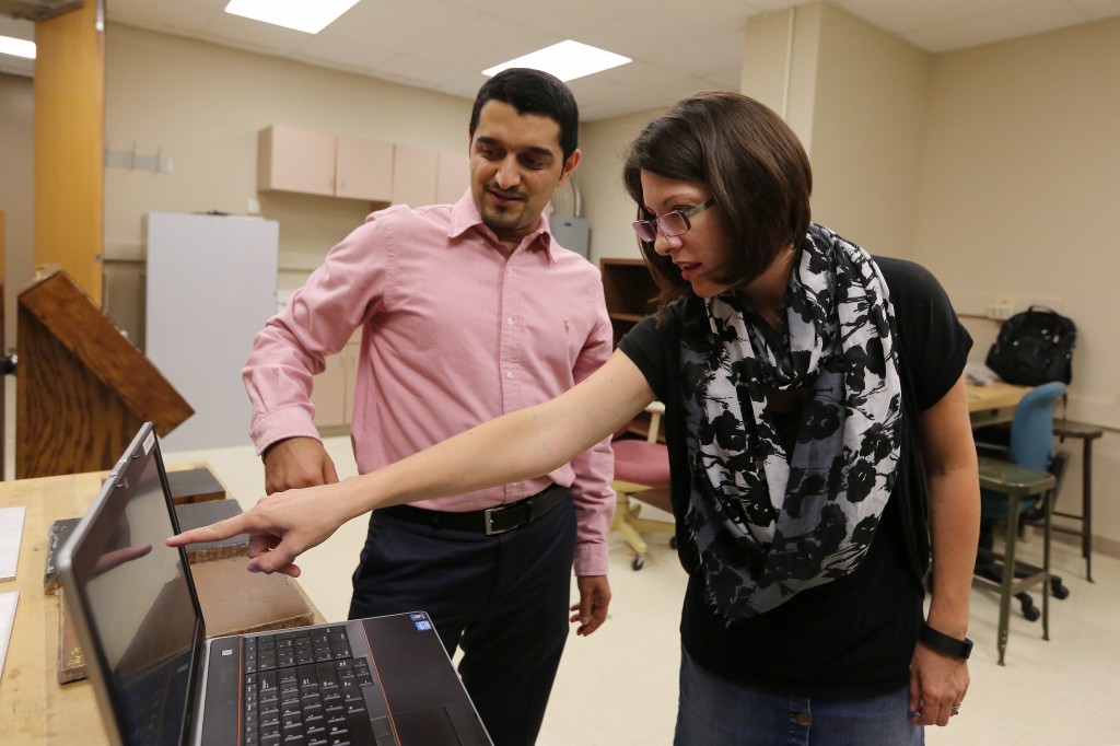 Professor Kristen Donnell, right, points to results of an active microwave thermography test that she and Ph.D. student Ali Foudazi run. Their work points out flaws within concrete or rehabilitated aluminum and could lead to increased safety for motorists and airline passengers.