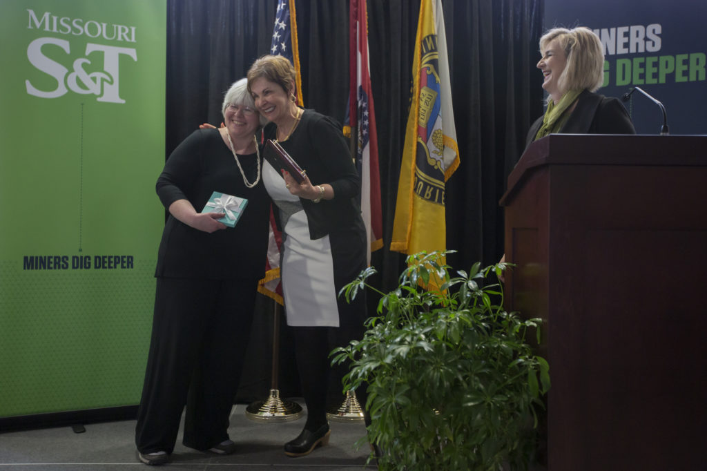 Missouri S&T professor Suzanna Long, left, embraces Cynthia Tang as Chancellor Cheryl B. Schrader looks on. Long was named the Missouri S&T Woman of the Year on Wednesday, April 20. Tang, a member of the Missouri S&T Board of Trustees, funds the award. Sam O'Keefe/Missouri S&T