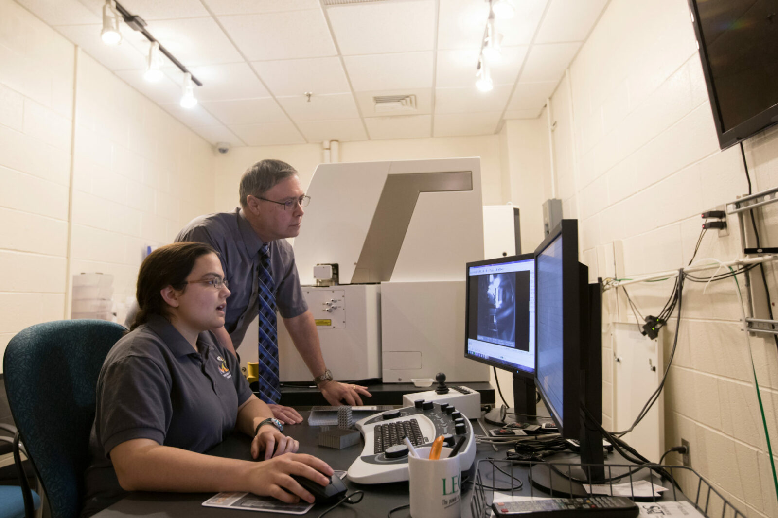 Professor Joseph Newkirk and Myranda Spratt, a Ph.D. student in materials science and engineering, examine images of a stainless steel allow designed to be lighter than conventional alloys. Sam O'Keefe/Missouri S&T