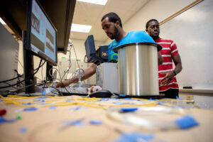 Tennessee State University students Ahmed Osmand (foreground) and Sam Wreh were among the students selected for Missouri S&T's Summer Engineering Research Academy. They are shown here working on fiber optic sensors for use in their metallurgical engineering research. Photo by Tom Wagner/Missouri S&T, ©2019 Missouri S&T