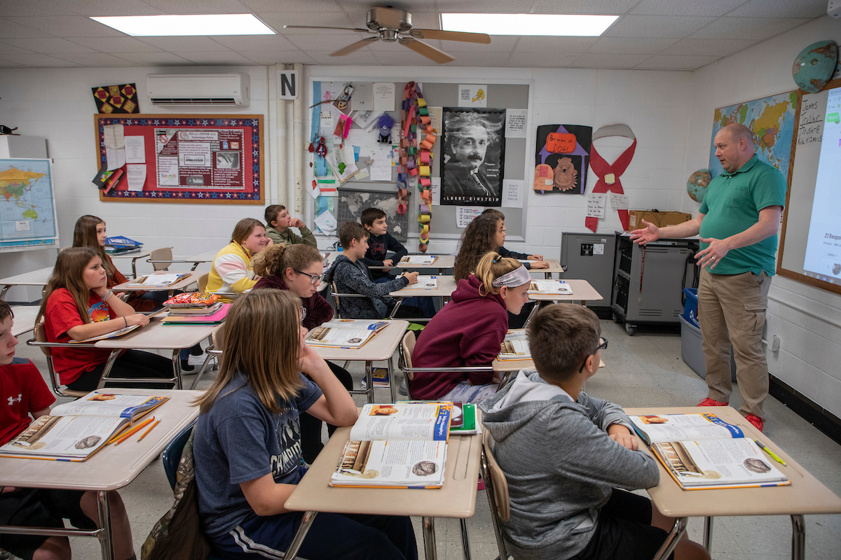 middle school teacher with students