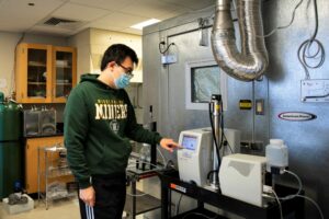 Photo of Ph.D. student Weixing Hao working at the lab used to study bioaerosols