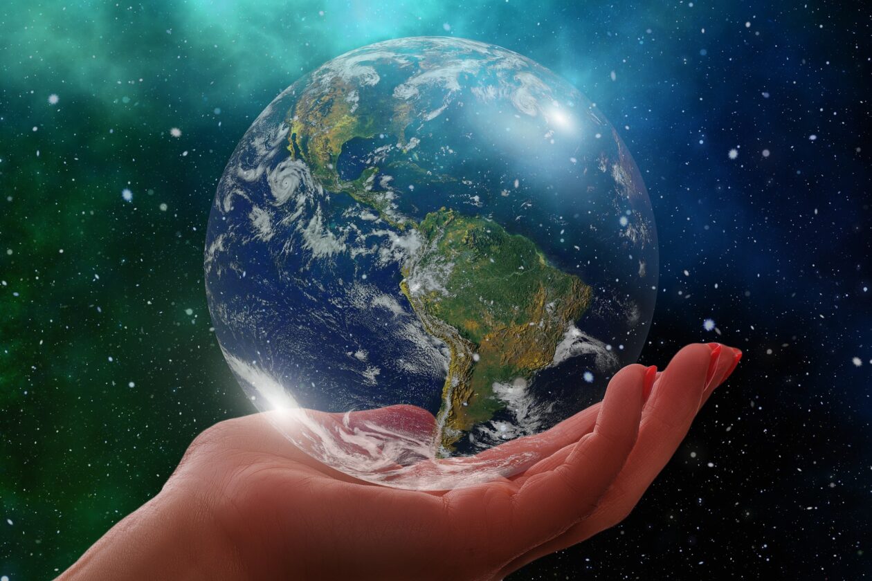 Hand holding a transparent globe