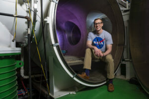 Photo of David Lund with plasma vacuum chamber at Missouri S&T