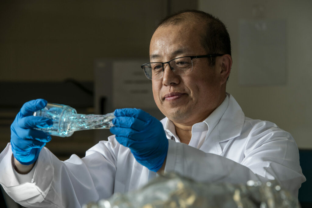 Photo of Dr. Baojun Bai and the particle gel he's researching