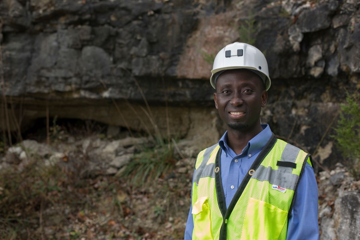 Photo of Dr. Kwame Awuah-Offei in white hard hat and yellow safety vest outside Missouri S&T's experimental mine