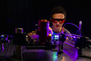 Photo of Jack Fletcher in nuclear lab with safety goggles