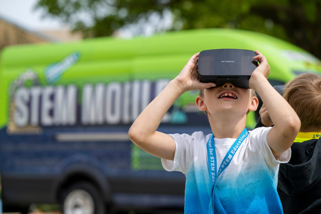 Child with VR headset in front of STEM Mobile