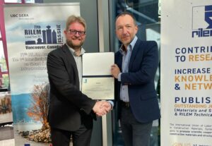 Dr. Nicolas Roussel, RILEM president, presents Dr. Dimitri Feys with a certificate in honor of him becoming a RILEM Fellow. Photo courtesy of Daniela Ciancio.