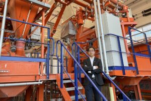 Dr. Hongyan Ma with S&T's semi-industrial scale concrete batching plant.