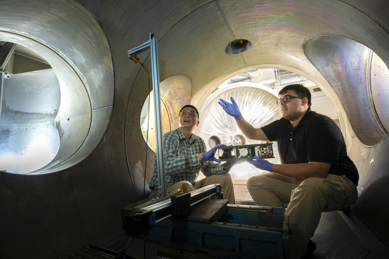 Ph.D. student Jacob Ortega works with Dr. Daoru Han in Missouri S&T’s plasma vacuum chamber. Photo by Michael Pierce/Missouri S&T.