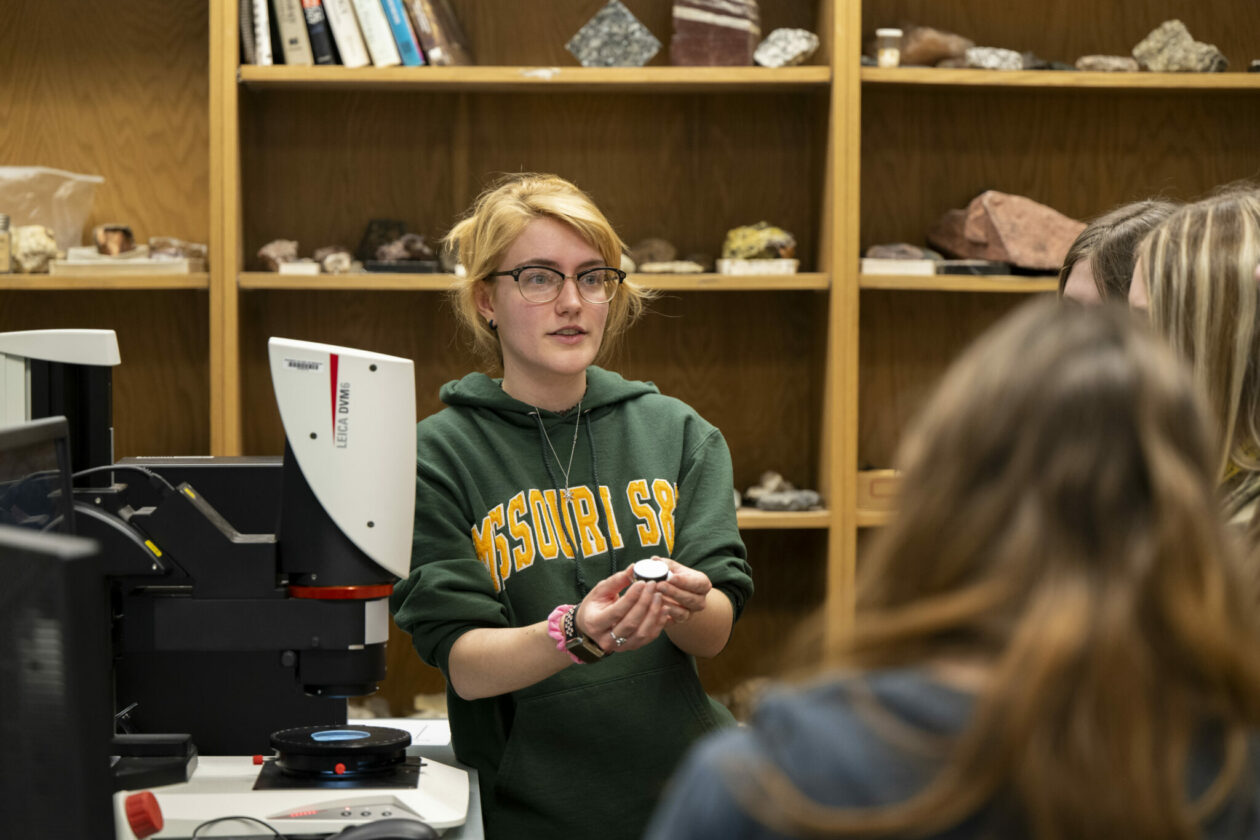 Regan Swain, a graduate research assistant for the project, shows a rock sample to a group of middle- and high-school students who visited S&T during National Engineers Week. Photo by Michael Pierce/Missouri S&T.