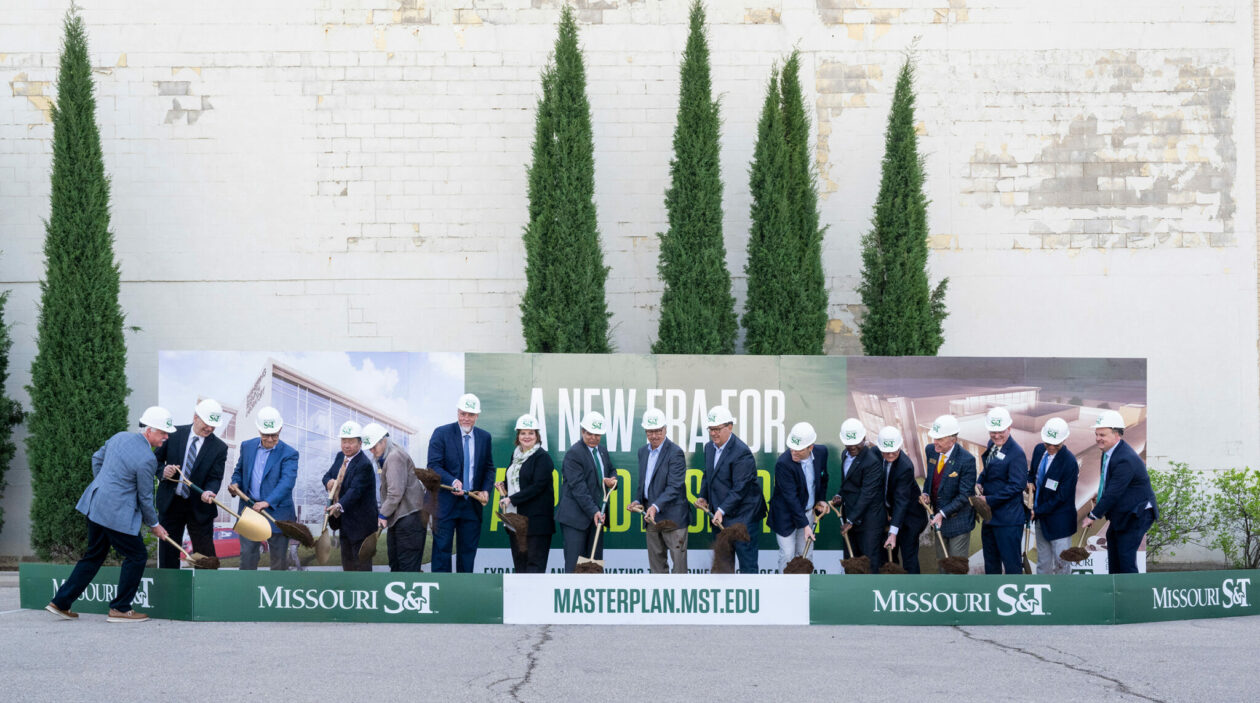 Leaders with shovels at dig box