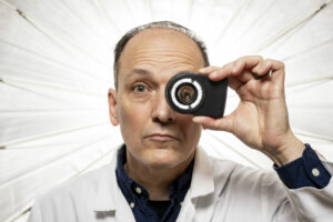Dr. Joe Stanley looks through a dermoscope — a device used to detect and examine skin cancer. Photo by Michael Pierce/Missouri S&T.