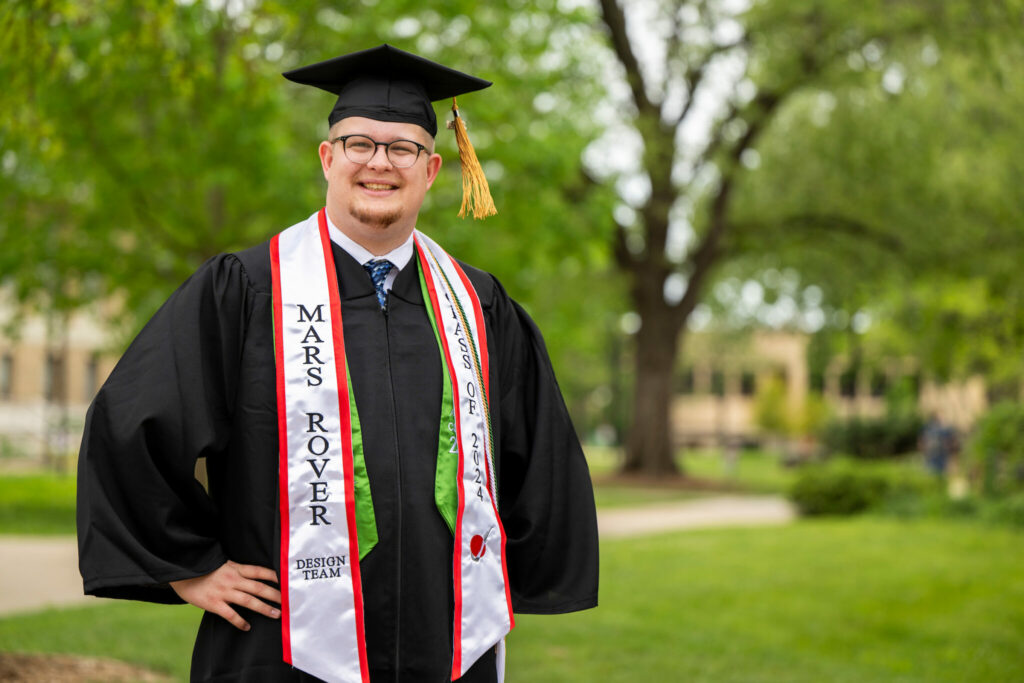 Maxwell Ryan in cap and gown on S&T's campus