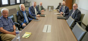 Eric Smith, center right, Tech Hubs program director for the U.S. Economic Development Administration (EDA), and Chad Eggen, front right, an EDA economic development representative, visit with Missouri S&T leaders during the university’s critical minerals national workshop. Photo by Terry Barner/Missouri S&T.