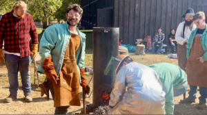 Jeremiah Cohn, second from left, looks to the crowd and announces: “We’ve got molten iron!” Photo by Greg Edwards/Missouri S&T.