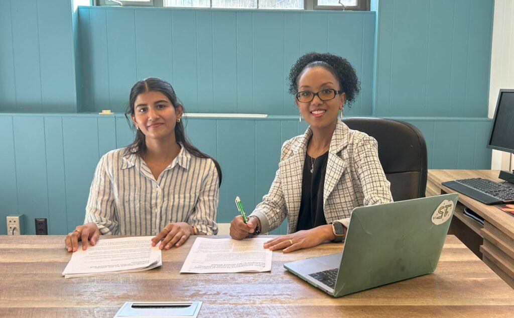 Sreeja Koppera and Dr. Mahelet Fikru working in Harris Hall.