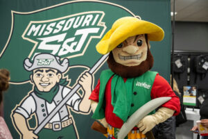 Joe Miner, right, helped unveil new artwork during a celebration in The S&T Bookstore on April 4.
