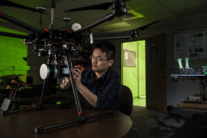 Dr. Xinzhe Yuan, a Missouri S&T alumnus, adjusts a drone in an S&T lab when he was a student in 2021. Photo by Michael Pierce/Missouri S&T.