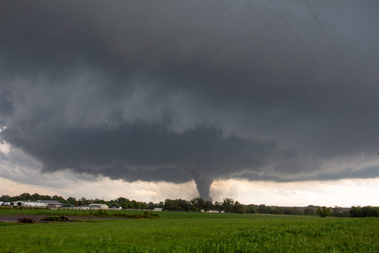 A tornado touches down near a farm. Photo by NZP Chasers/Adobe Stock.