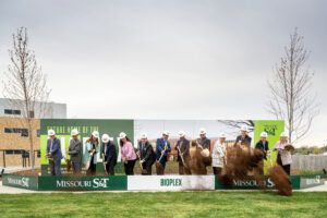 13 leaders shovel dirt during Bioplex groundbreaking ceremony on April 9