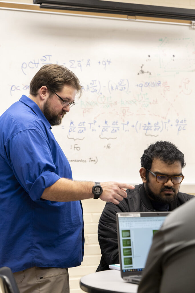 Dr. Joshua Schlegel teaching a student in a classroom at S&T.