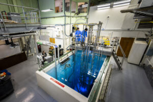 The Missouri S&T nuclear reactor glows blue with Cherenkov radiation from high-energy electrons moving faster than light in water. Photo by Michael Pierce/Missouri S&T.