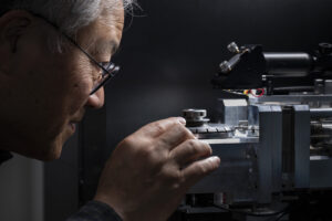 Dr. Frank Liou operates a mechanical testing device in a Missouri S&T laboratory. Photo by Blaine Falkena/Missouri S&T.