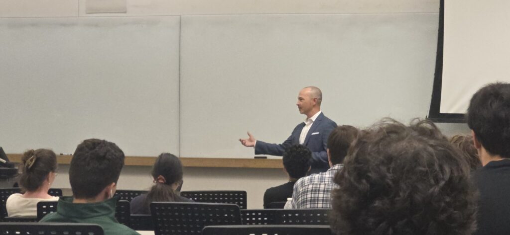 Nick Akers speaking to a class of students.