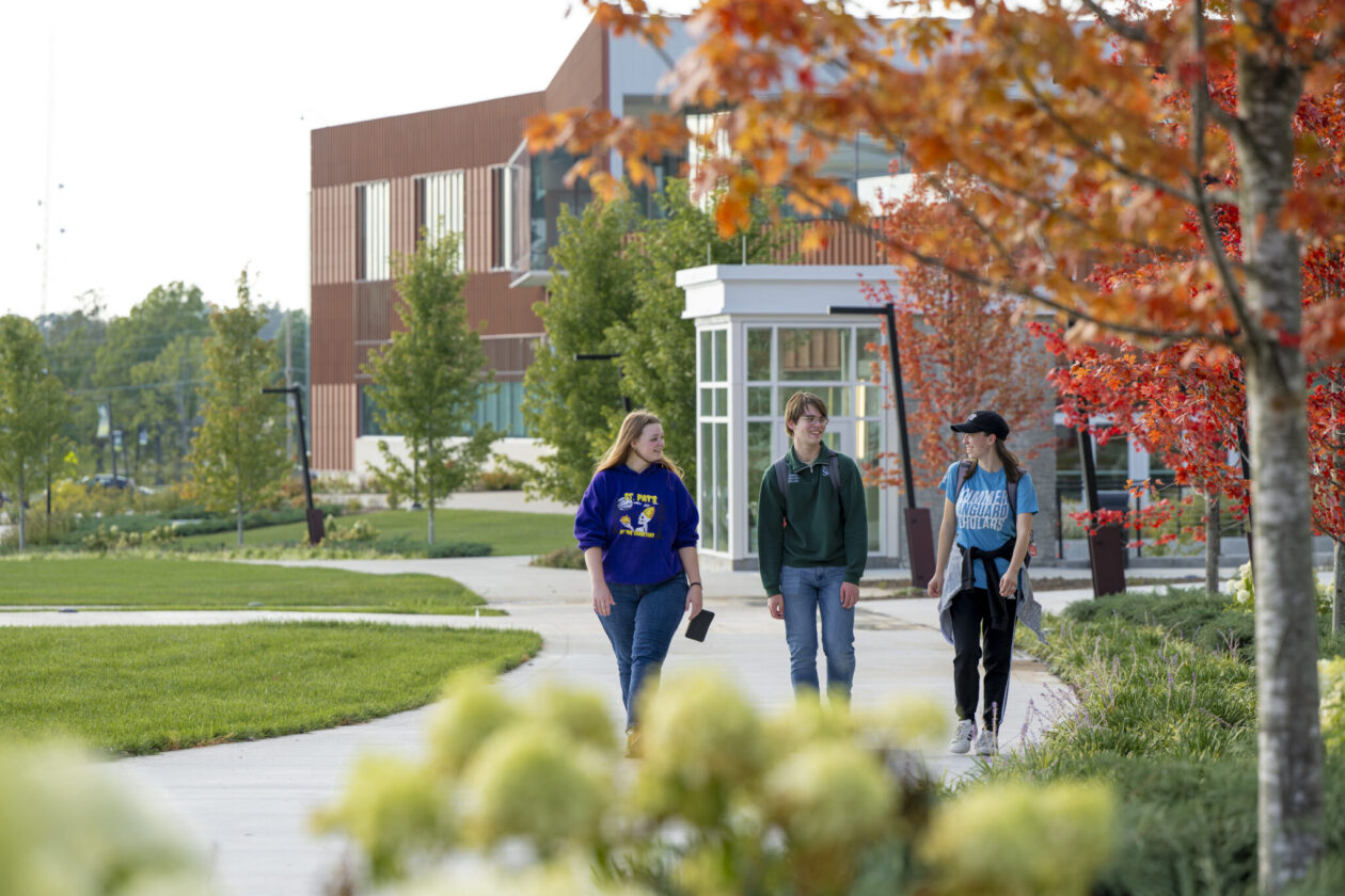 Three students walk outside of the Welcome Center on the campus of Missouri S&T.