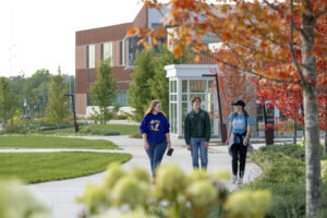 Three students walk outside of the Welcome Center on the campus of Missouri S&T.