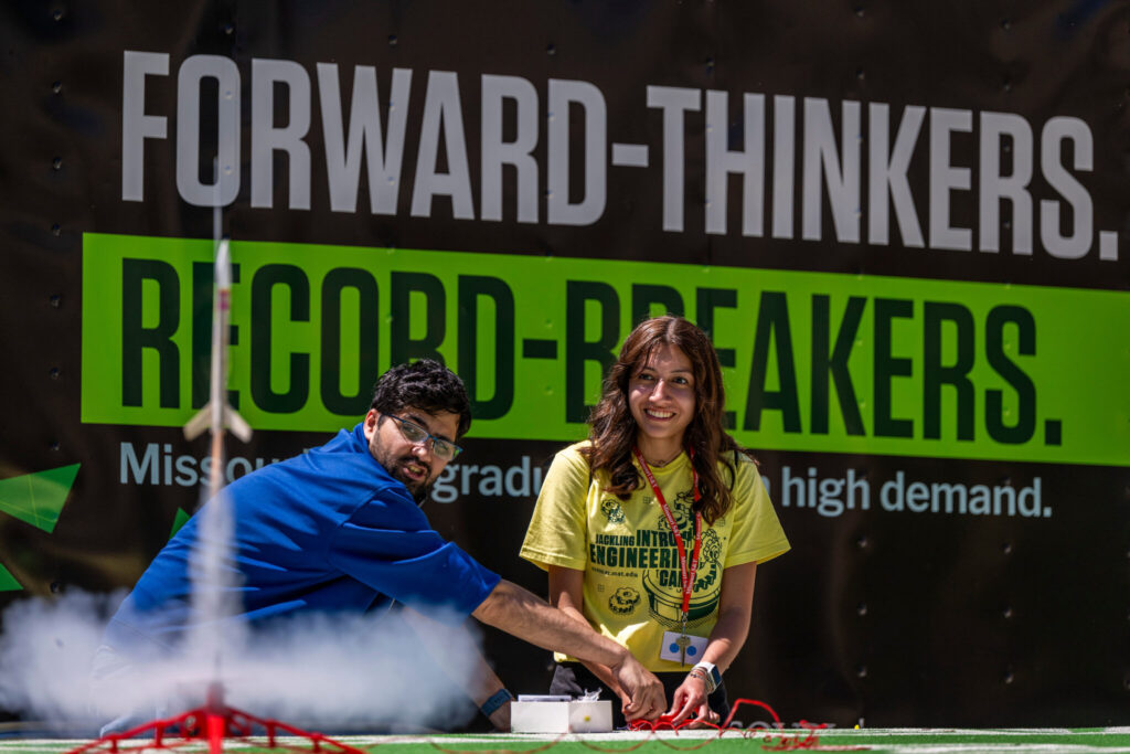 Two S&T camp participants launch a small rocket.