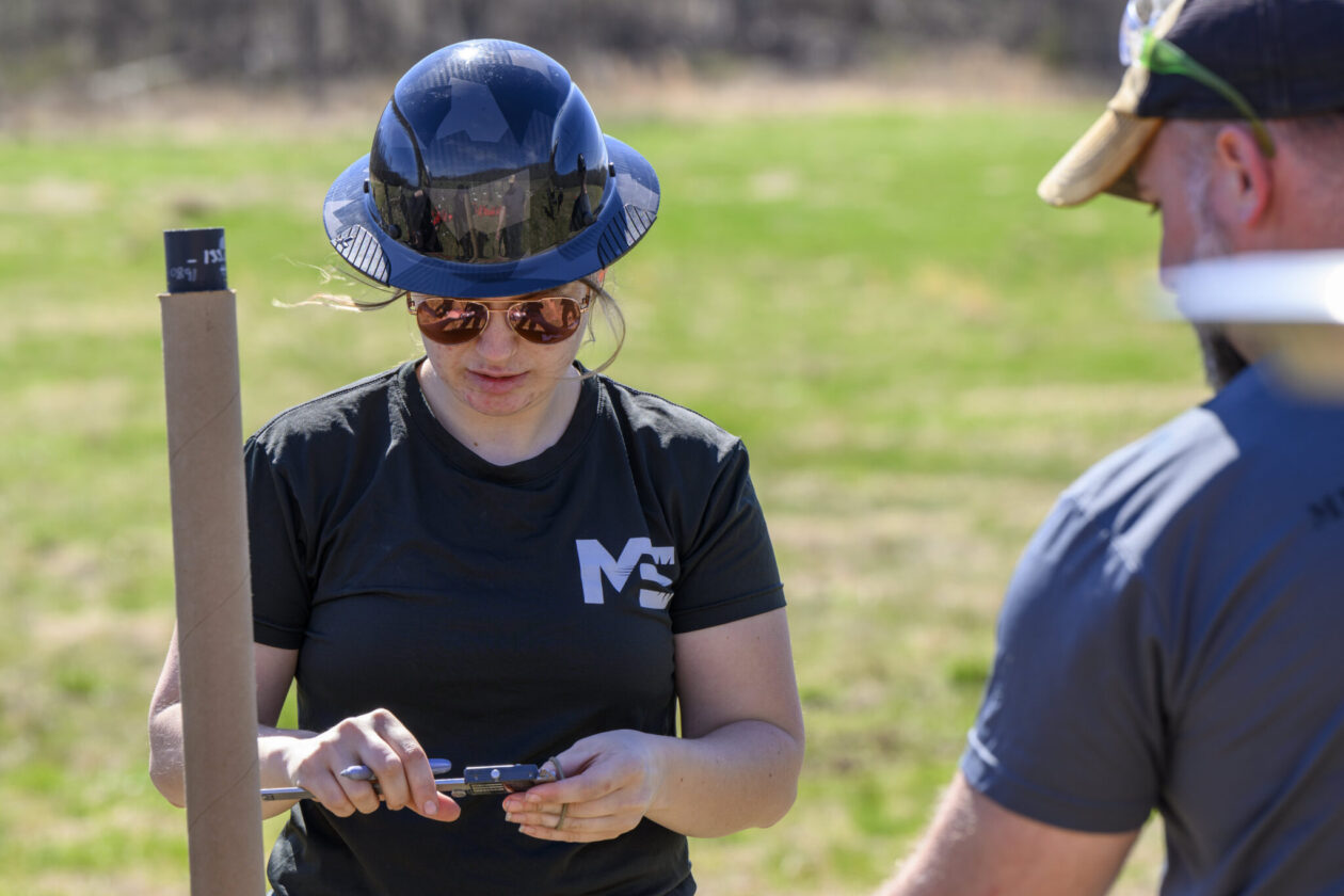 Avery Lyons takes measurements while conducting an explosives experiment with her mentor, Dr. Phillip Mulligan. Photo by Michael Pierce/Missouri S&T
