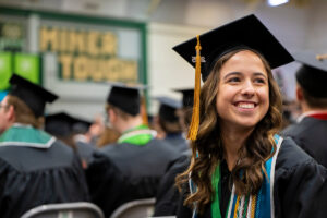 Smiling graduate at Missouri S&T commencement ceremony.