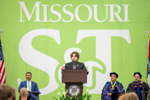 Aiden Pickett speaking to a crowd of new students.