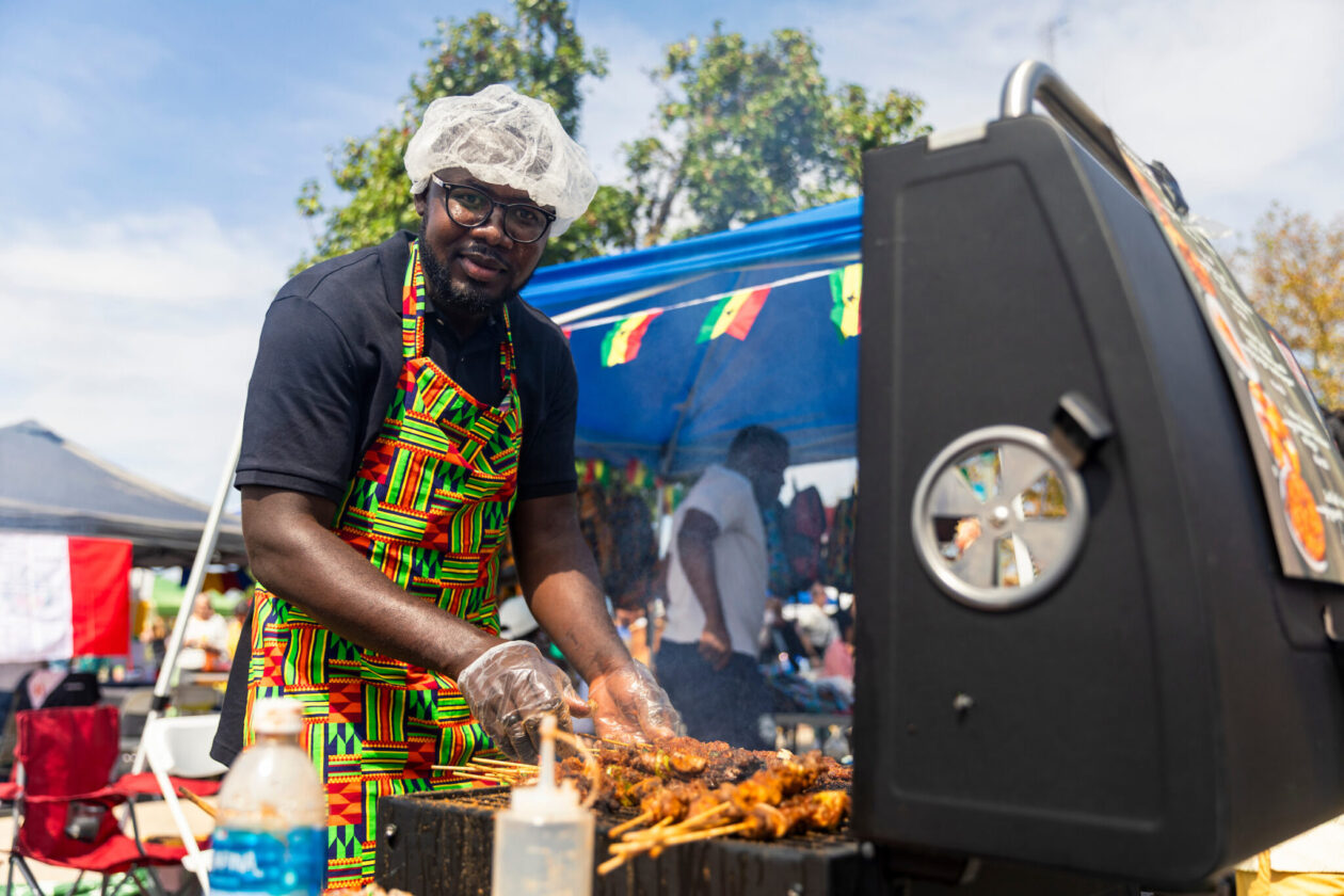 Man cooking at a large grill.