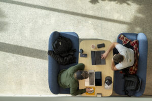 Two Missouri S&T students work on their laptops in the Innovation Lab forum.