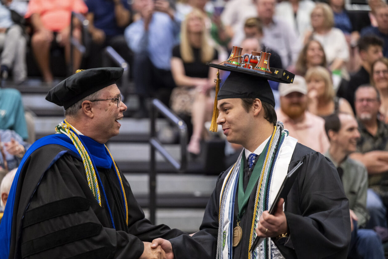 Dr. Joseph Newkirk, professor and chair of nuclear engineering and radiation science, congratulates Baur during a spring 2025 commencement ceremony. Photo by Blaine Falkena/Missouri S&T
