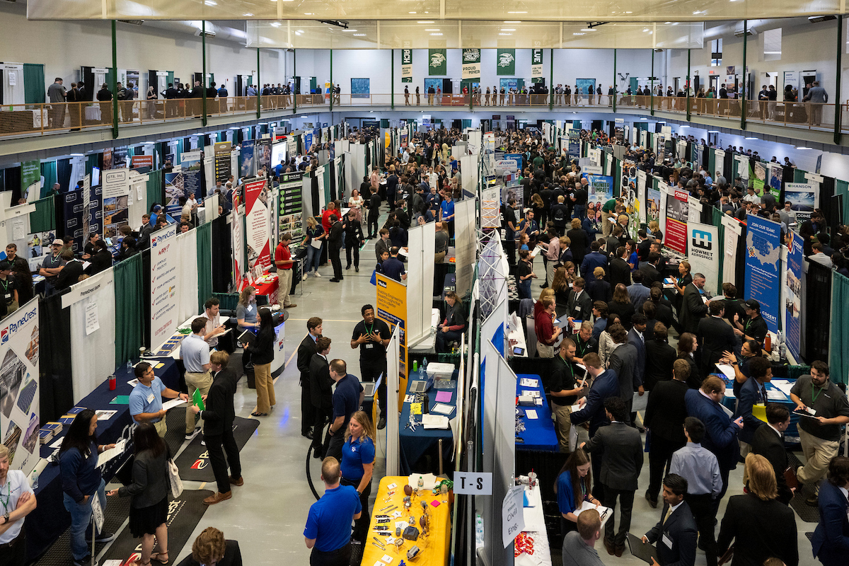 An overhead shot of Missouri S&T's 2025 fall career fair, showing students visiting employer booths in the Gale Bullman Building.