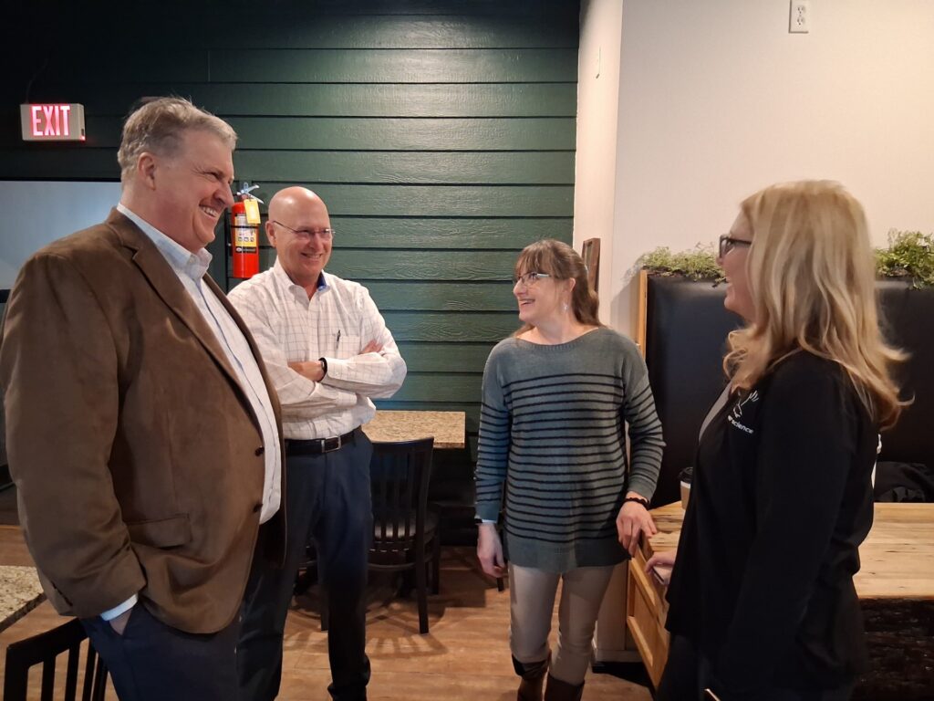A group of professionals network during a Rolla LOOP event at Coffeesmiths.