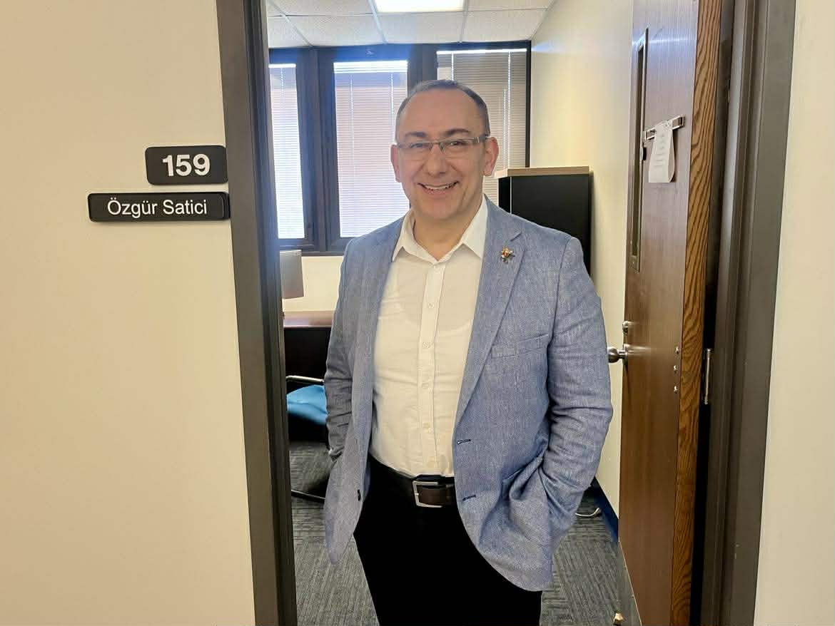 Dr. Özgür Satici stands outside his office in McNutt Hall.