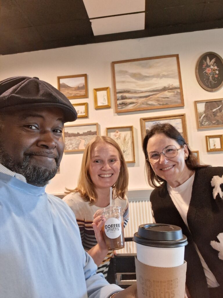 Three people meet up for the first Rolla LOOP event at Coffeesmiths. Shown is the three people taking a selfie while holding coffee cups.