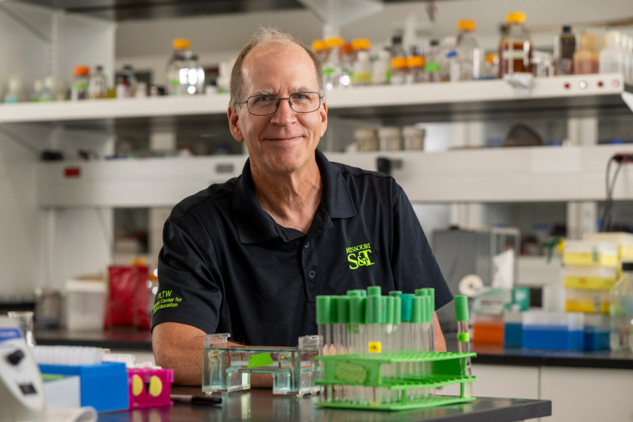 Man standing at laboratory bench.