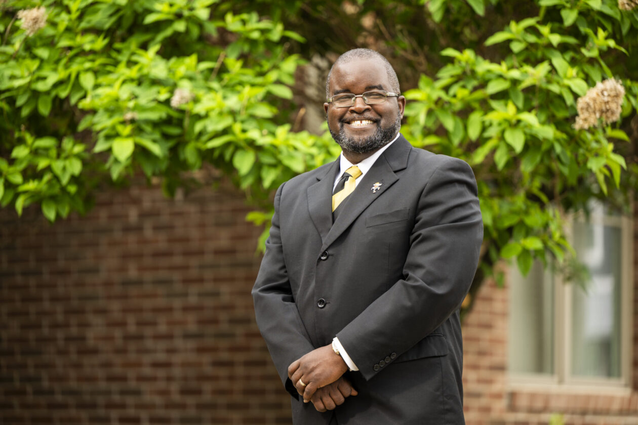 Lister Florence wearing a suit and standing outside